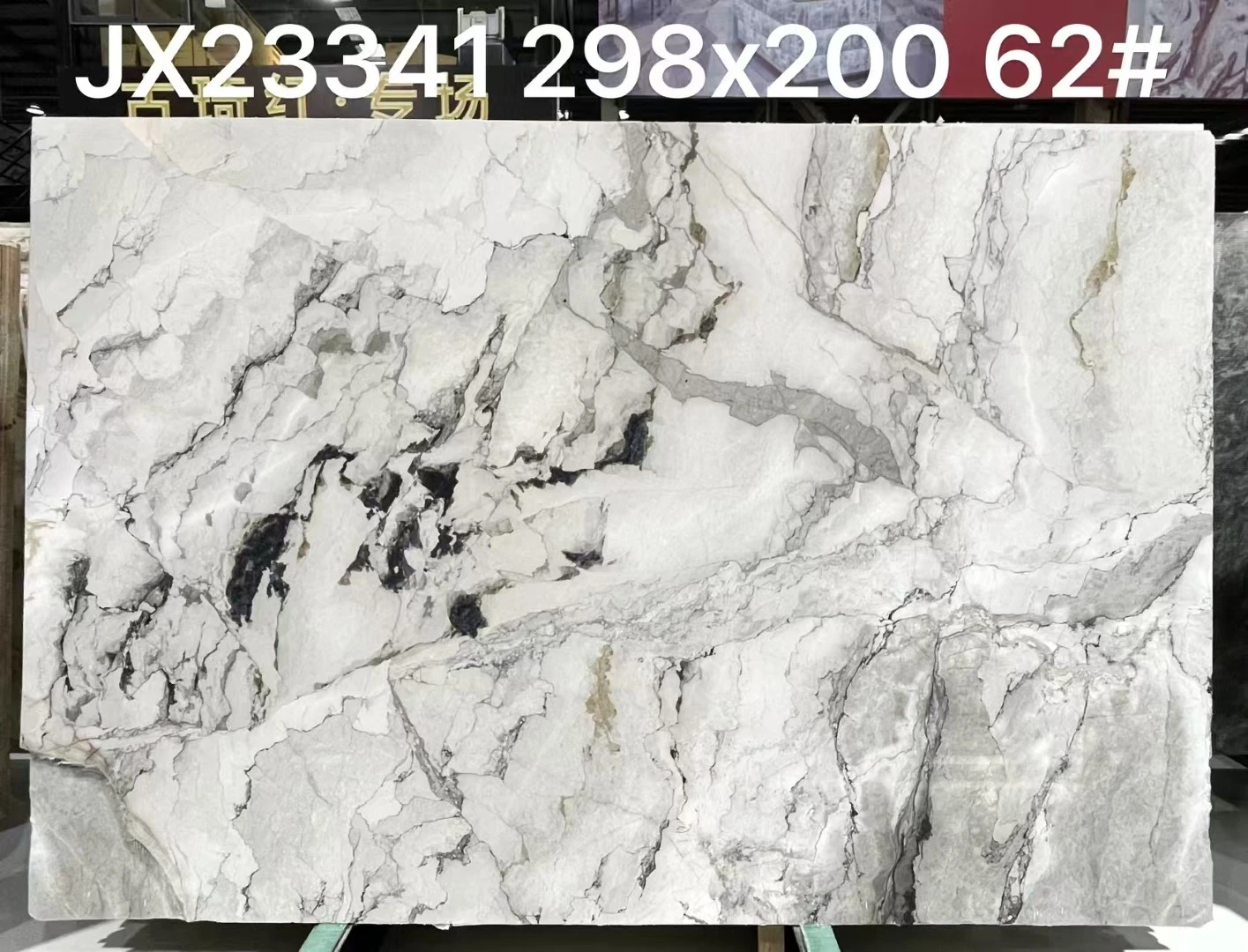 Honed Camouflage White Marble slab with a white background and dramatic gray, black and subtle beige veining displayed in Landiview Stone showroom Honed Camouflage White Marble slab with a white background and dramatic gray, black and subtle beige veining displayed in Landiview Stone showroom